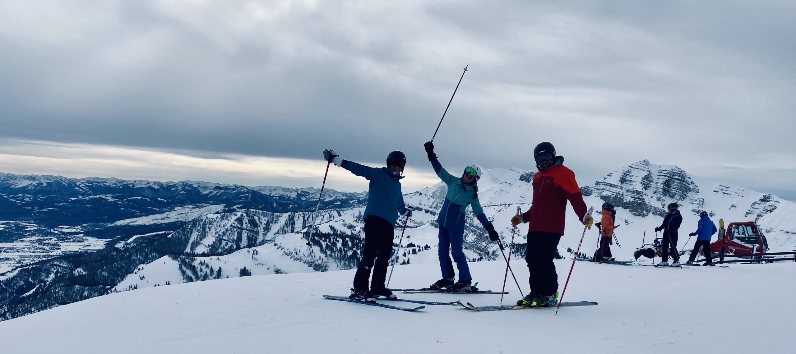 3 skiers ready to go on a crisp white slope