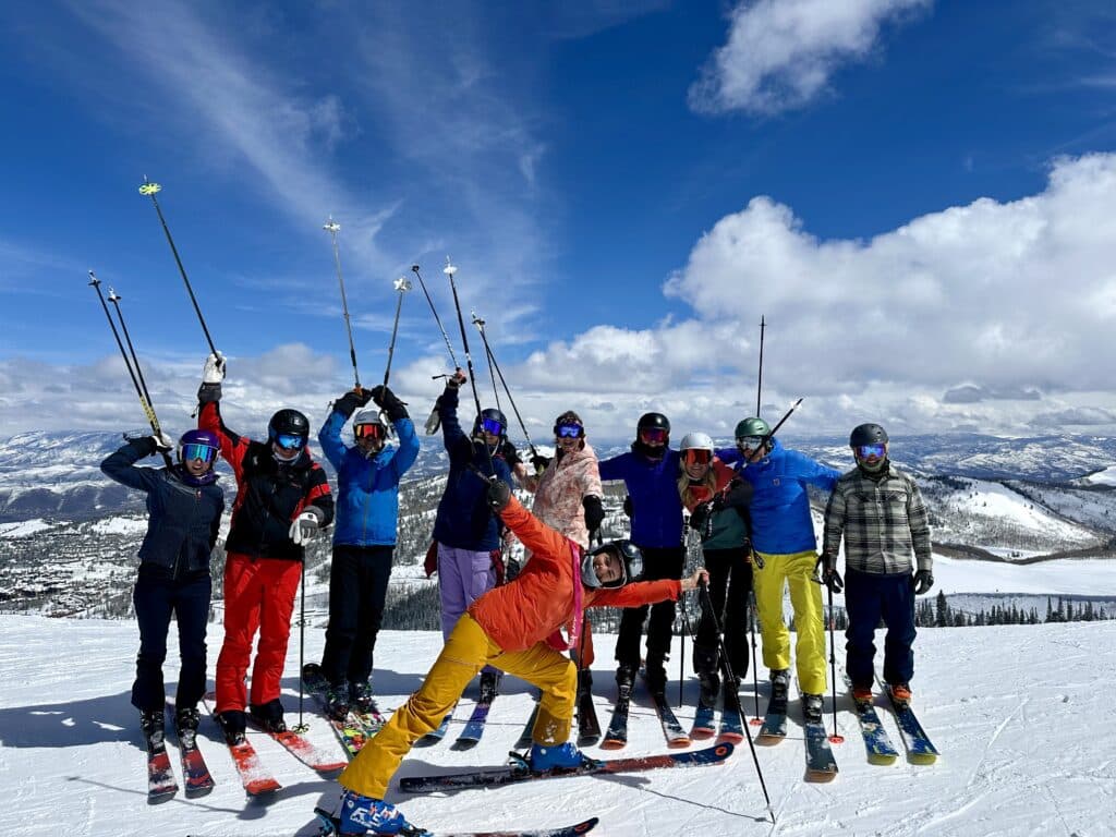 group of happy skiers posing on the slope